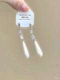 Geometric silver-tone alloy ear clips with rhinestones and hanging tassels, showing heart-shaped details