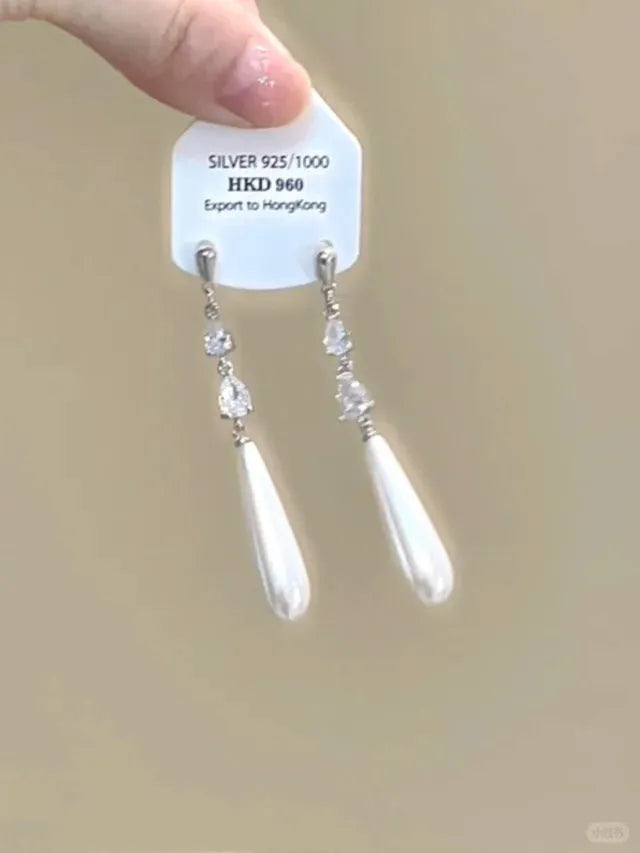 Geometric silver-tone alloy ear clips with rhinestones and hanging tassels, showing heart-shaped details