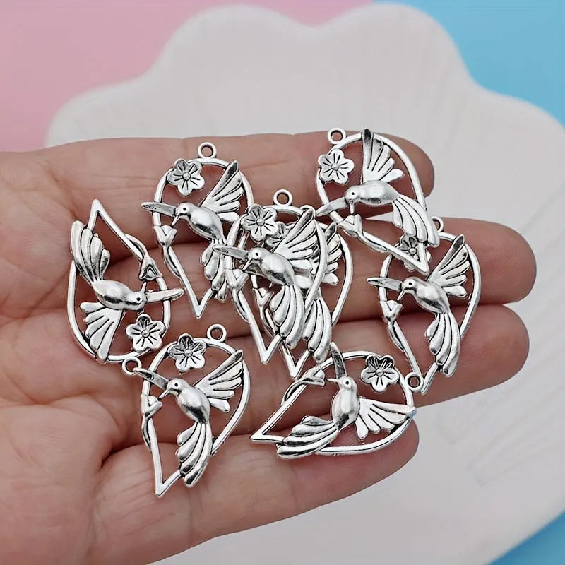 Silver-toned alloy DIY pendant with detailed magpie pattern, shown against a plain background.