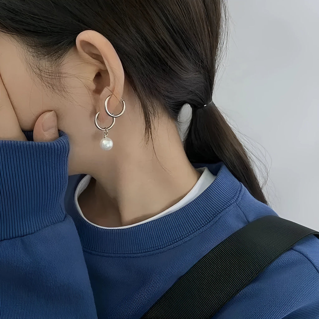 Geometric women's pearl drop earrings with alloy frame and titanium steel fittings.