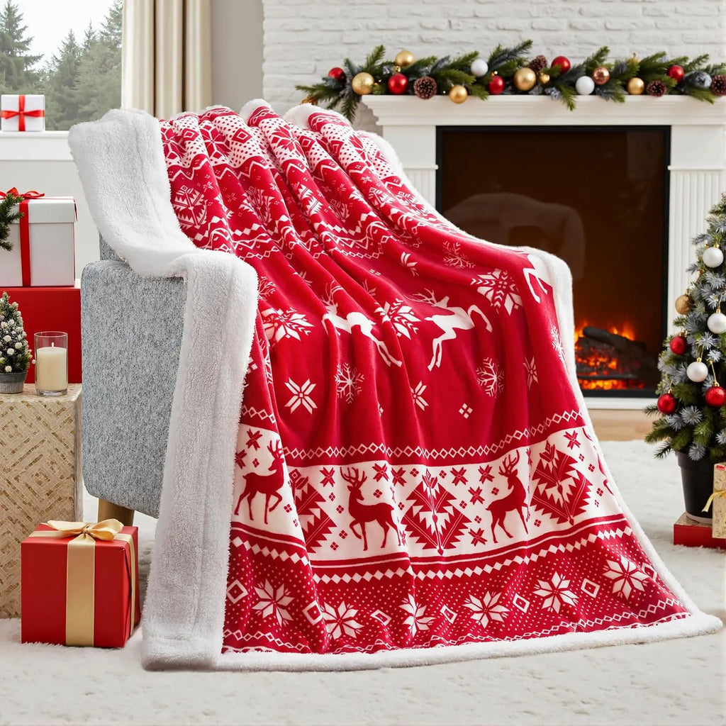 Soft red plush Christmas blanket draped over a sofa, showing its textured flannel fabric.