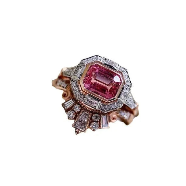 Rose gold alloy women's ring with a geometric design and ruby-coloured stone in a retro style.
