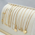 Ten gold necklaces with snake bone chains and alloy pendants displayed as complete jewellery set