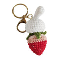 Hand-woven white rabbit strawberry cartoon charm pendant with a key attached