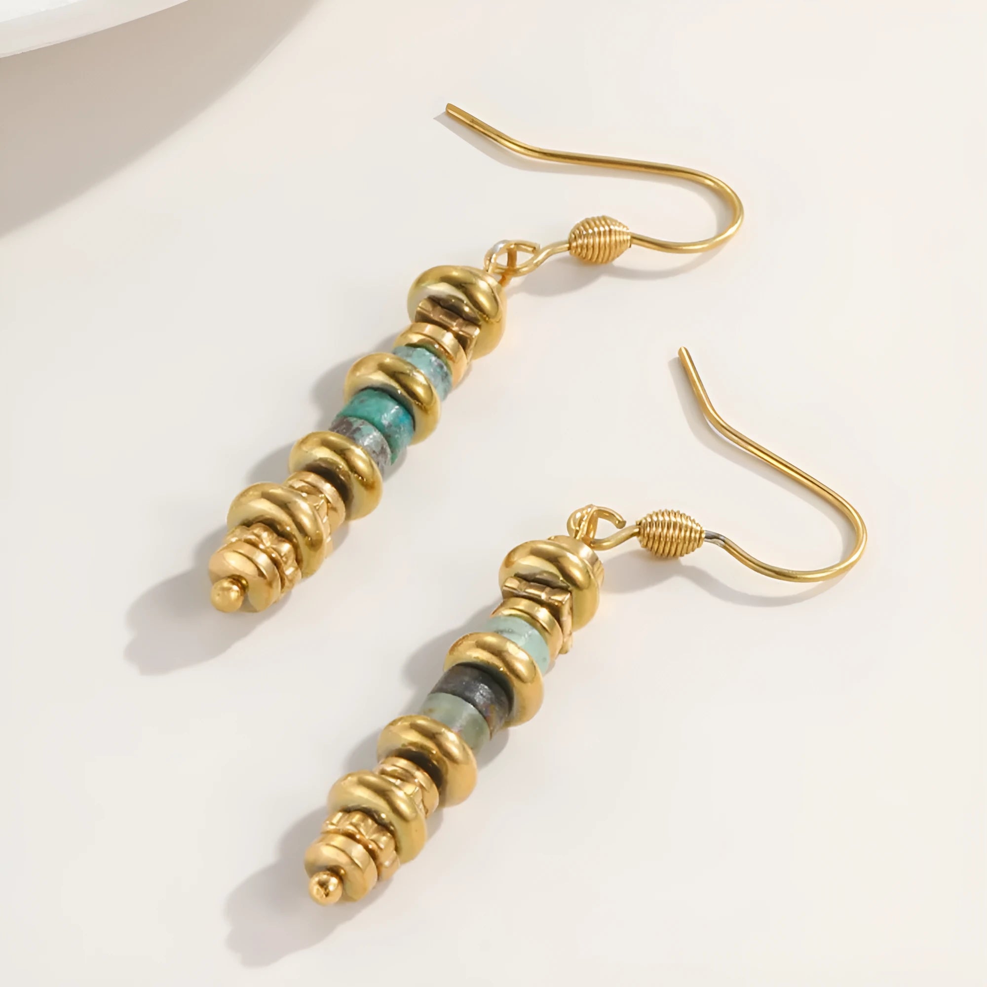 Titanium steel geometric dangle earrings in a retro style with an 18K plated finish.