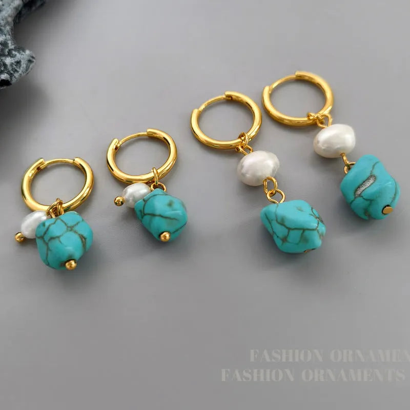 A pair of long dangle earrings with an irregular turquoise geometric clip and a cultured pearl drop on a copper setting.