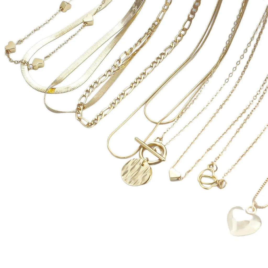 Ten gold necklaces with snake bone chains and alloy pendants displayed as complete jewellery set