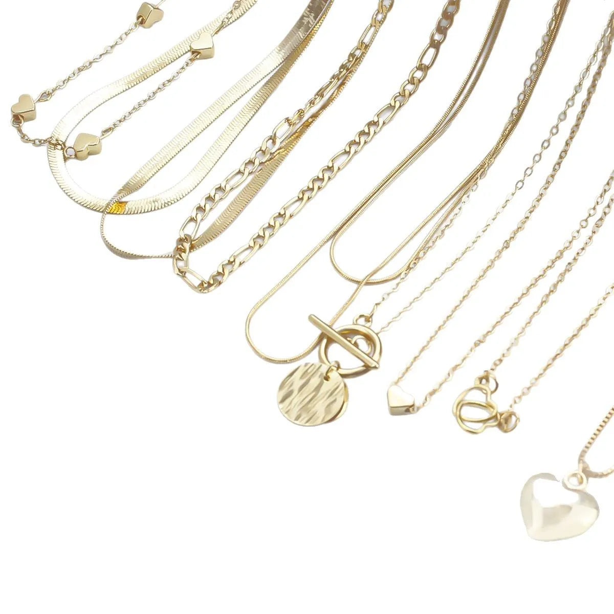 Ten gold necklaces with snake bone chains and alloy pendants displayed as complete jewellery set