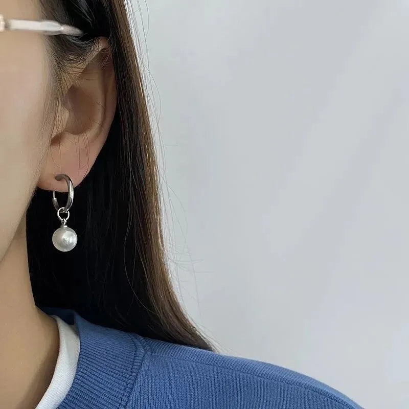 Geometric women's pearl drop earrings with alloy frame and titanium steel fittings.
