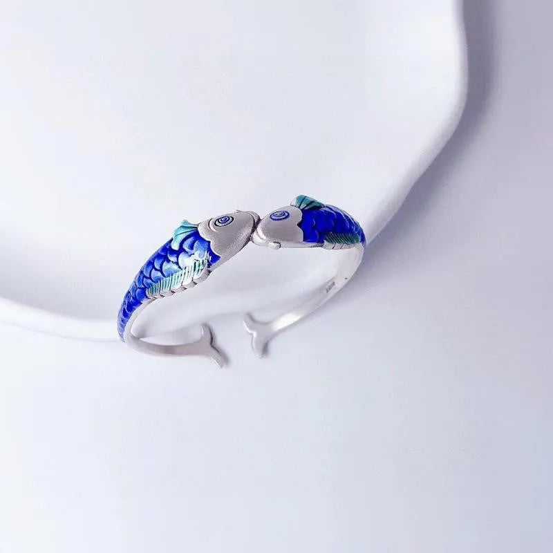 Silver electroplated copper bangle with blue carp design under glossy epoxy finish, 60mm diameter.