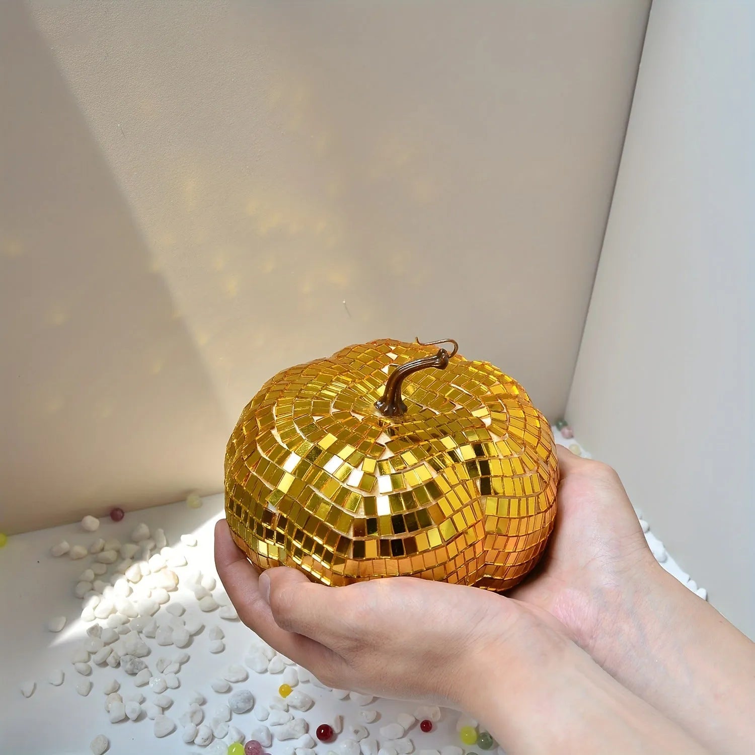 Chinese style glass Halloween pumpkin decoration in five different sizes on a dark surface.