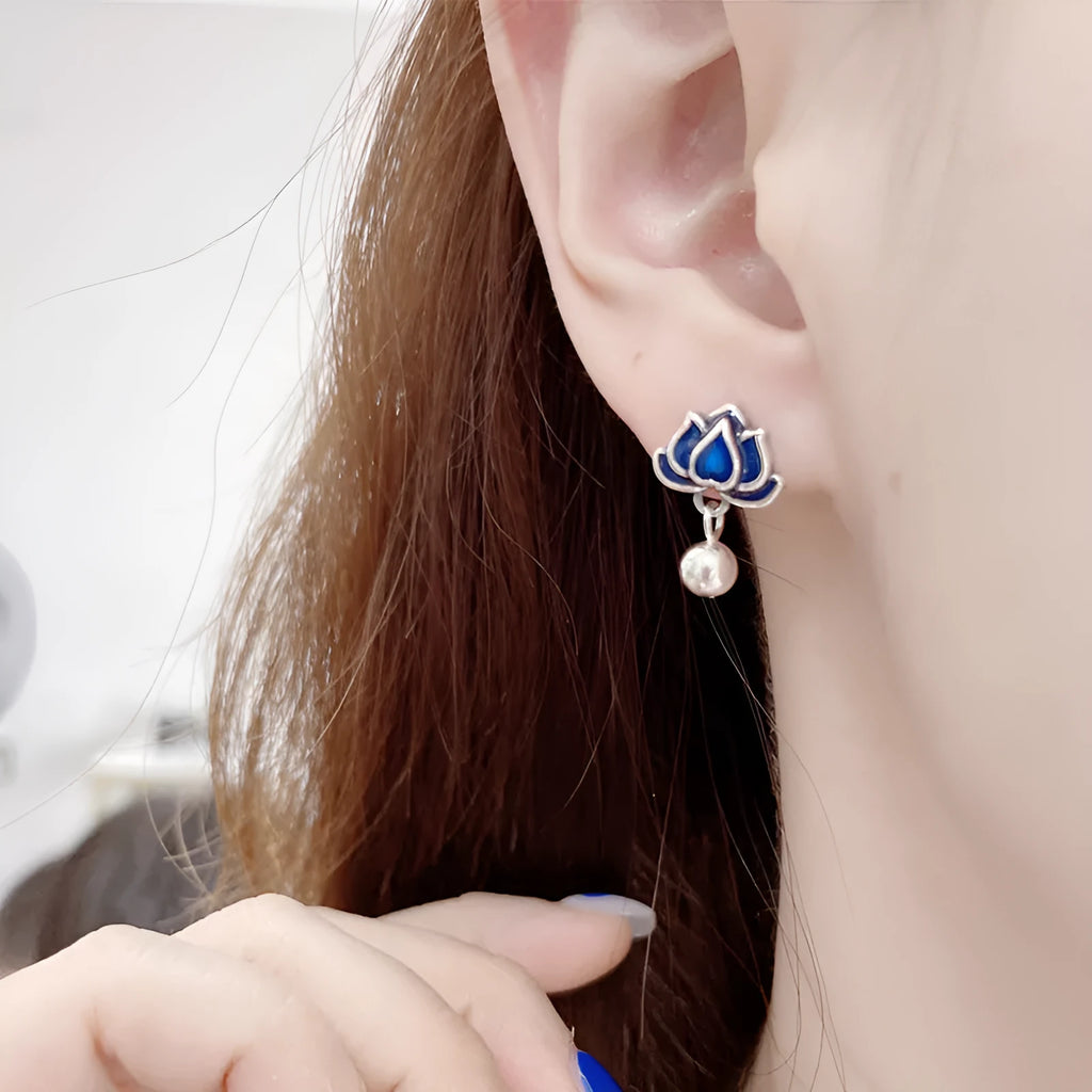 Blue lotus flower and seedpod tassel drop earrings with silver needle details on alloy studs.