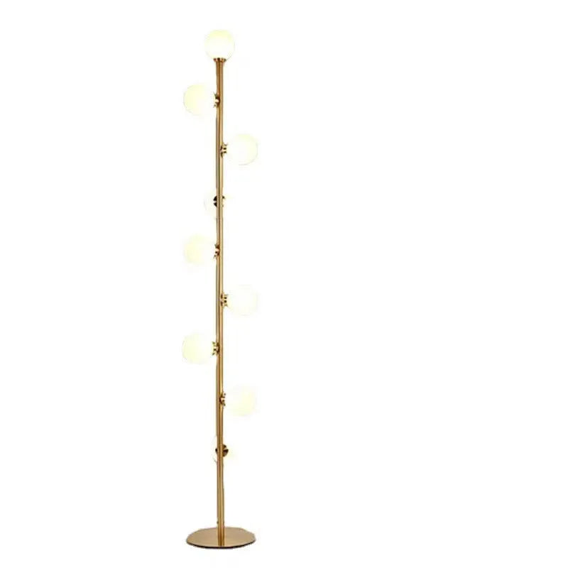 Tall modern floor lamp with glass shade and ironwork base on a wooden floor, showing minimalist Nordic design.