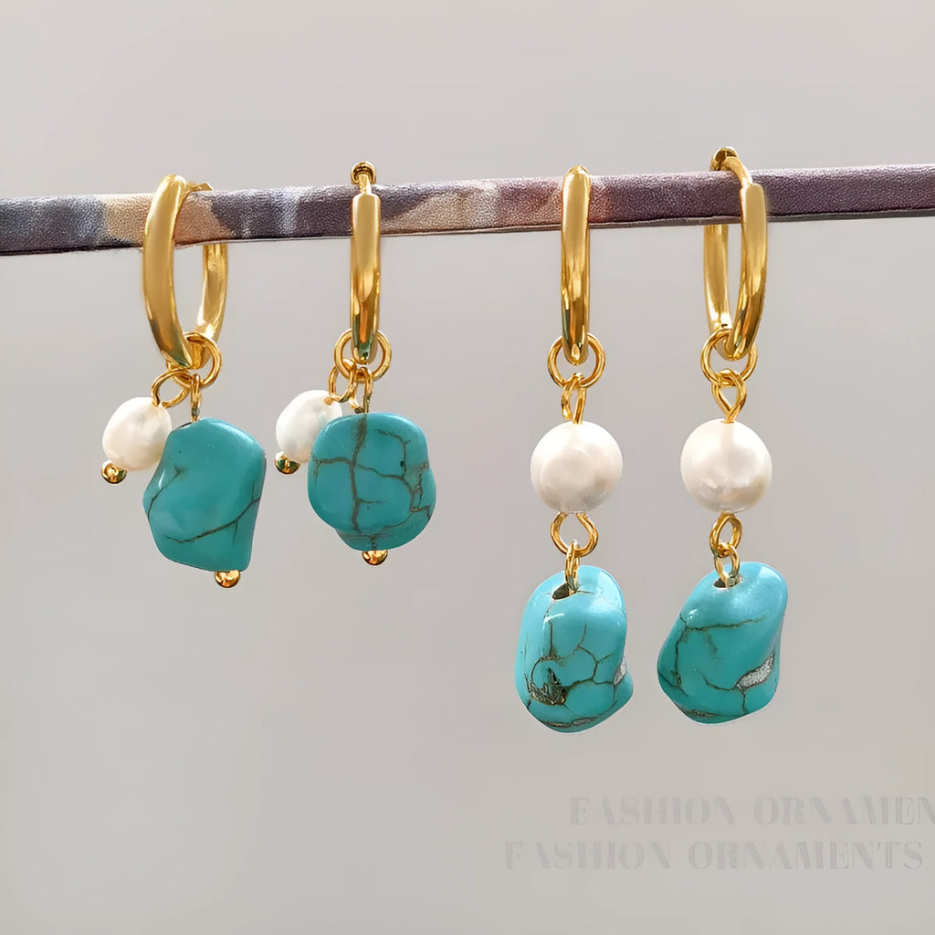 A pair of long dangle earrings with an irregular turquoise geometric clip and a cultured pearl drop on a copper setting.