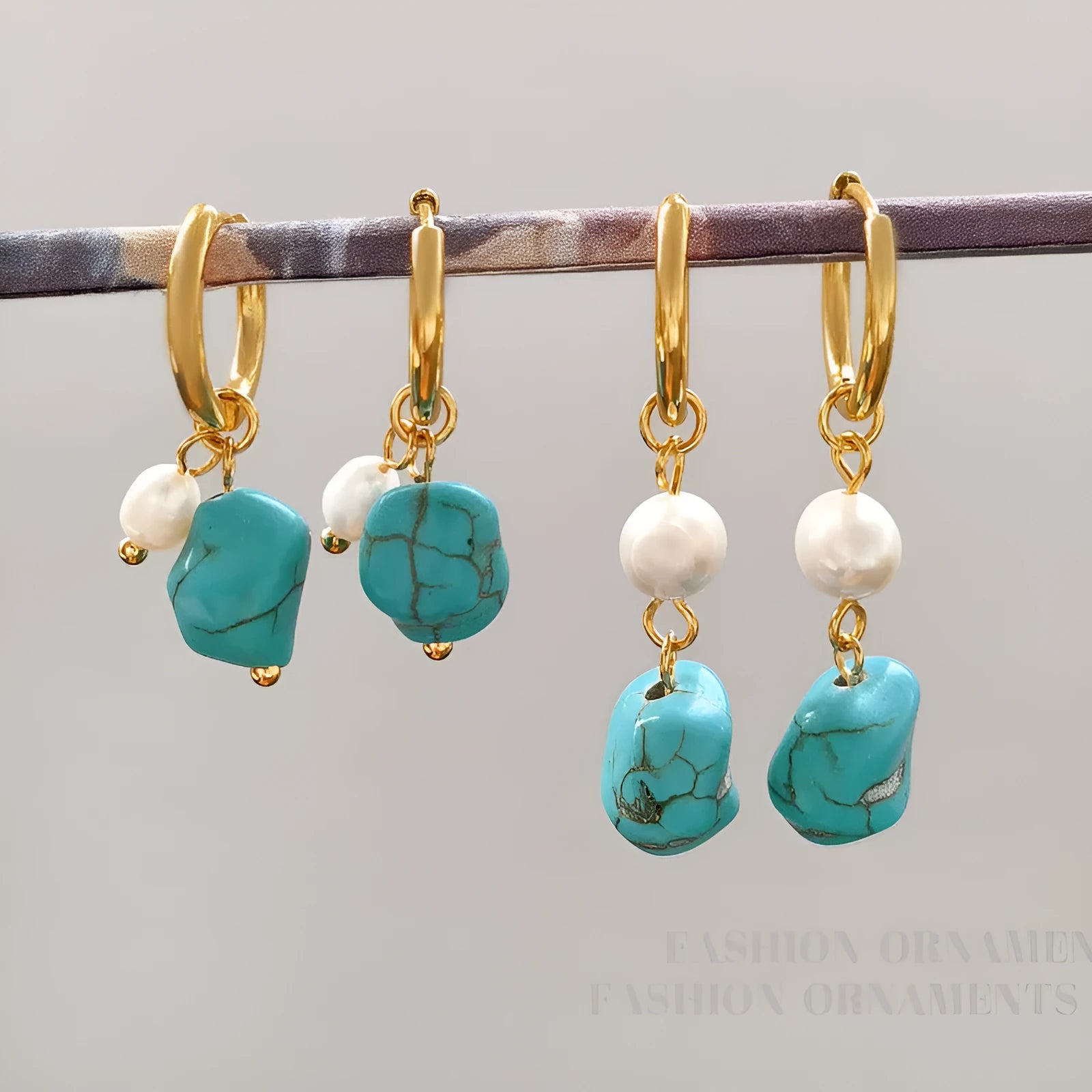A pair of long dangle earrings with an irregular turquoise geometric clip and a cultured pearl drop on a copper setting.