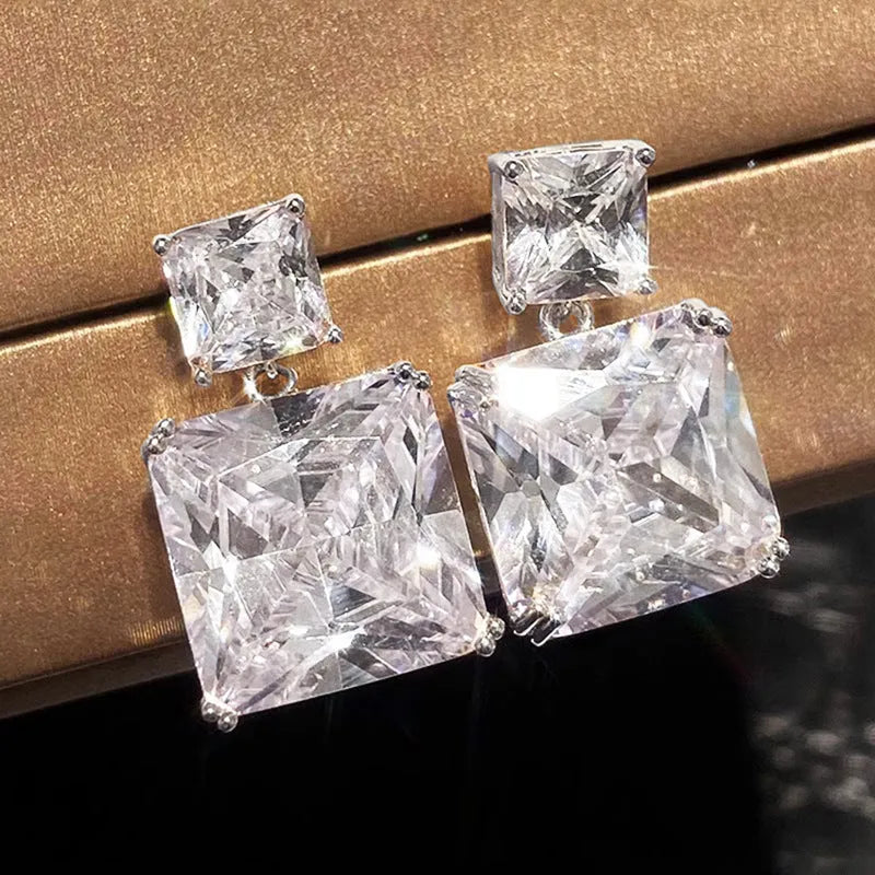 A pair of women's geometric square earrings in copper with a choice of white gold or gold colour finish.