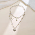 Women's retro alloy love heart pendant necklace with multi-layer pearl chain and double-layer heart design