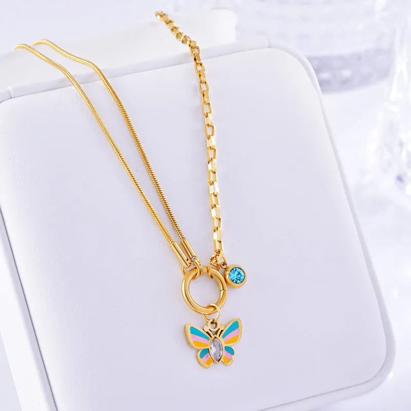 Gold colour titanium steel necklace and bracelet set with a detailed epoxy butterfly charm.