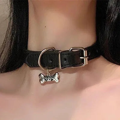 Black adjustable leather dog collar with decorative bone charm on a regular chain