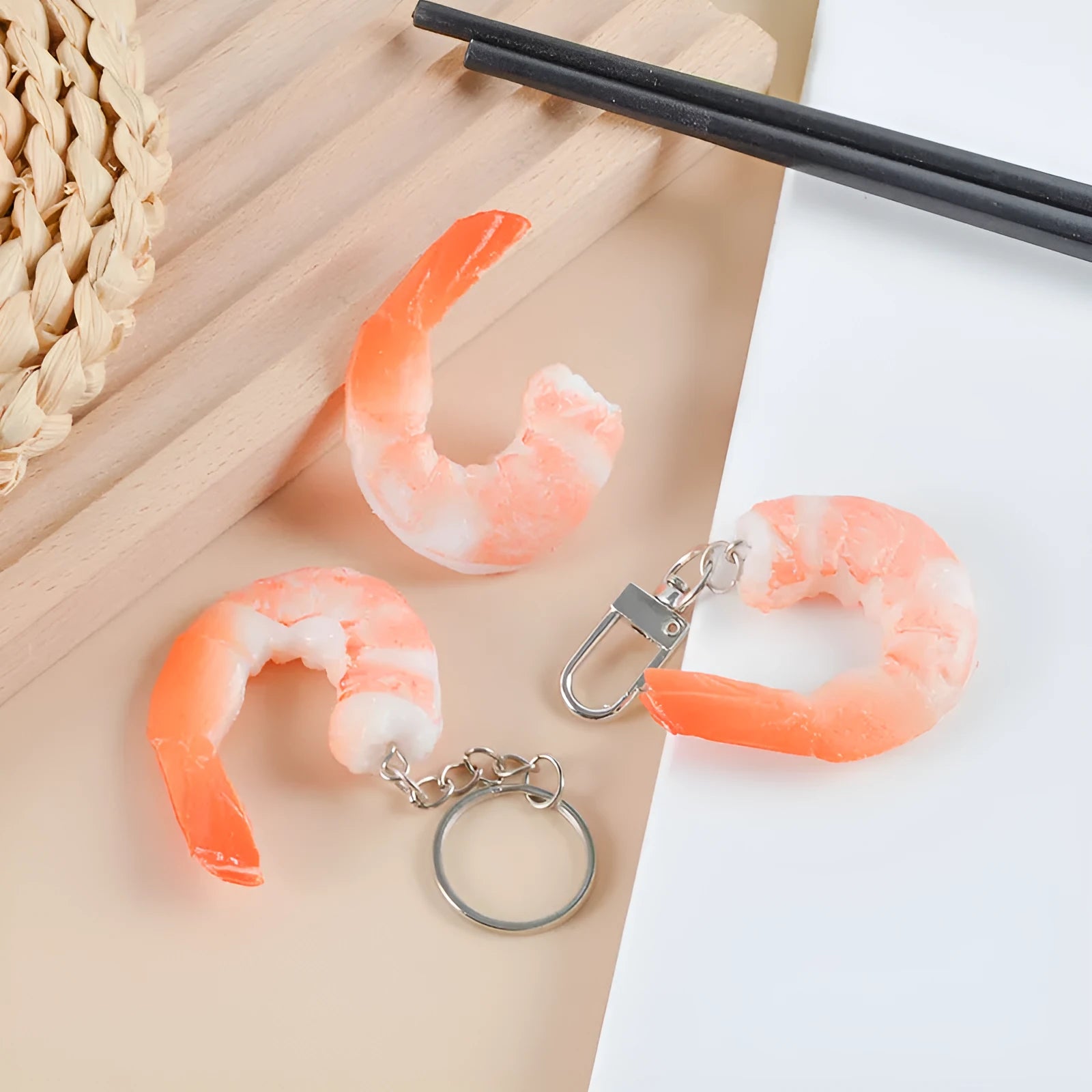 PVC injection moulded shrimp-shaped keychain with door buckle function, shown in modern simplicity style.