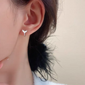 Women's fashion earrings with fishtail element design in white gold or yellow gold colour