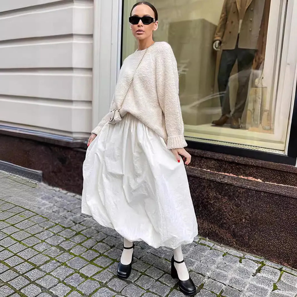 Women's solid colour long cotton skirt on a hanger, available in black and white.