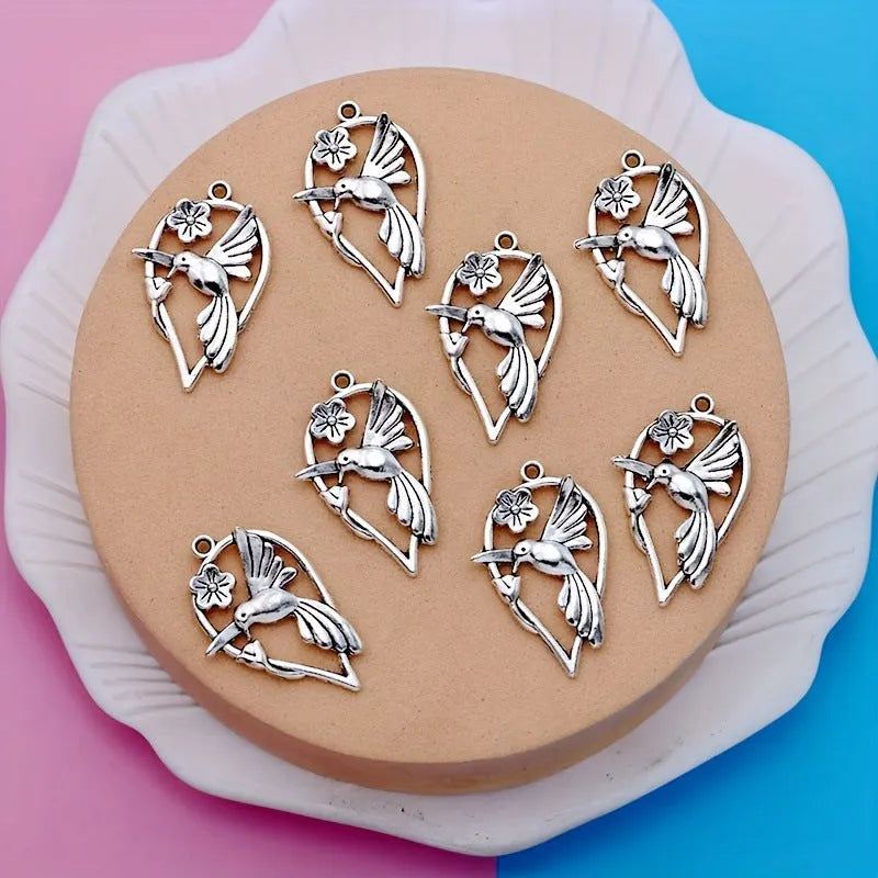 Silver-toned alloy DIY pendant with detailed magpie pattern, shown against a plain background.