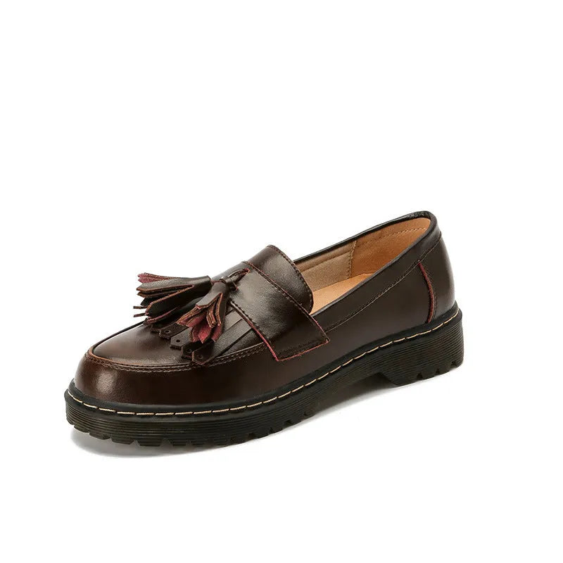 Women's brown leather loafers with tassel detail and a low chunky heel.
