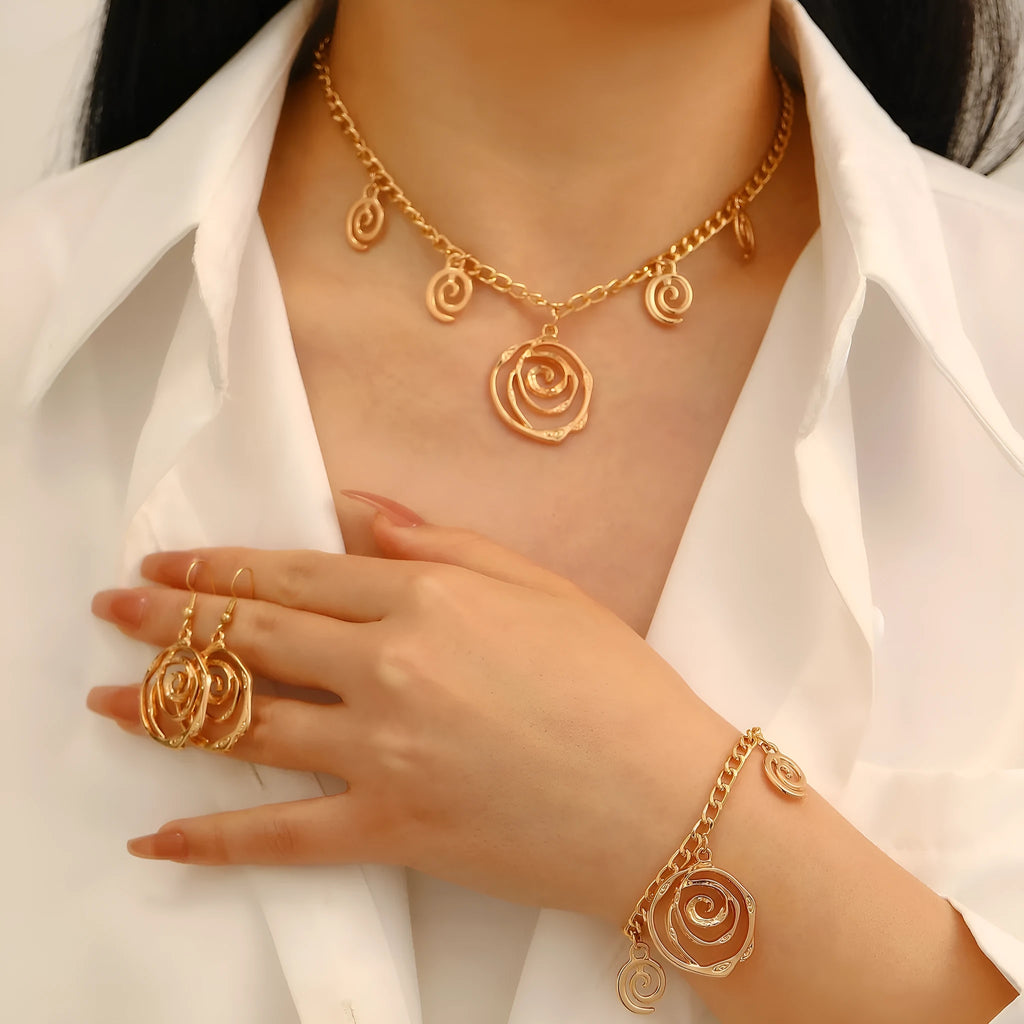Spiral donut design jewellery set showing necklace, bracelet and ear hooks in gold finish