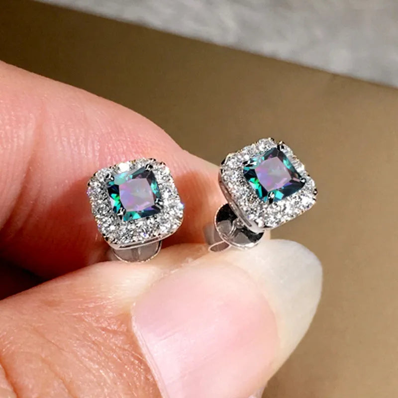 Square-cut grandmother green zircon stud earrings in electroplated copper with gold or white gold colour options.