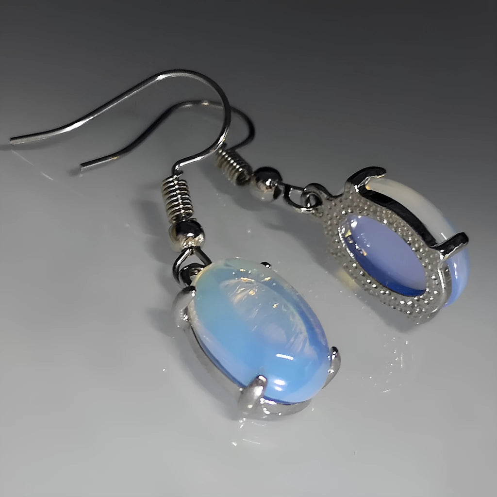 A pair of opal drop earrings with a retro moonstone design and electroplated alloy finish in a moonlight white colour.