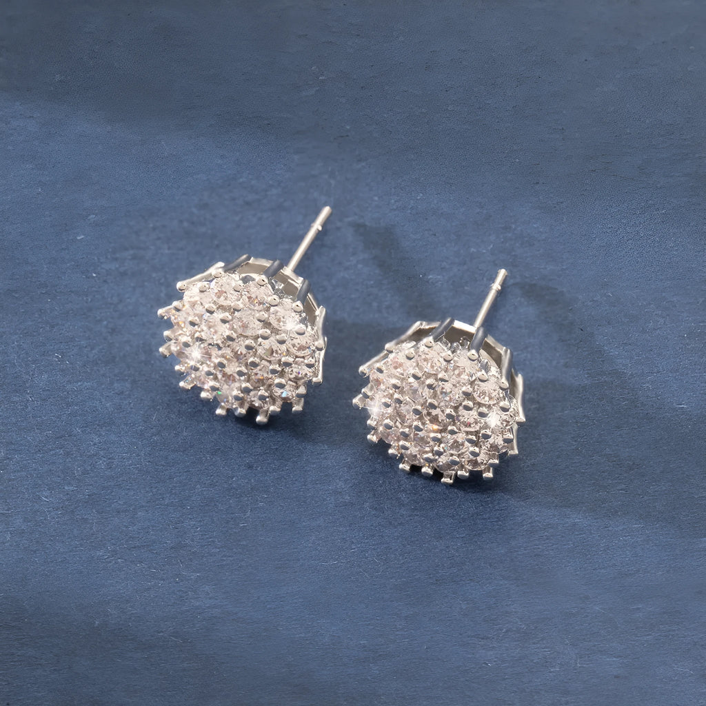 Pair of copper electroplated stud earrings in silver with irregular and round shapes on white background