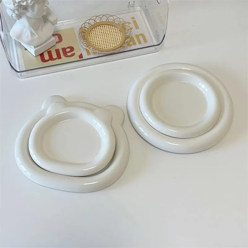 White porcelain plate with doodle design, shown in round and bear shapes, small and large sizes.