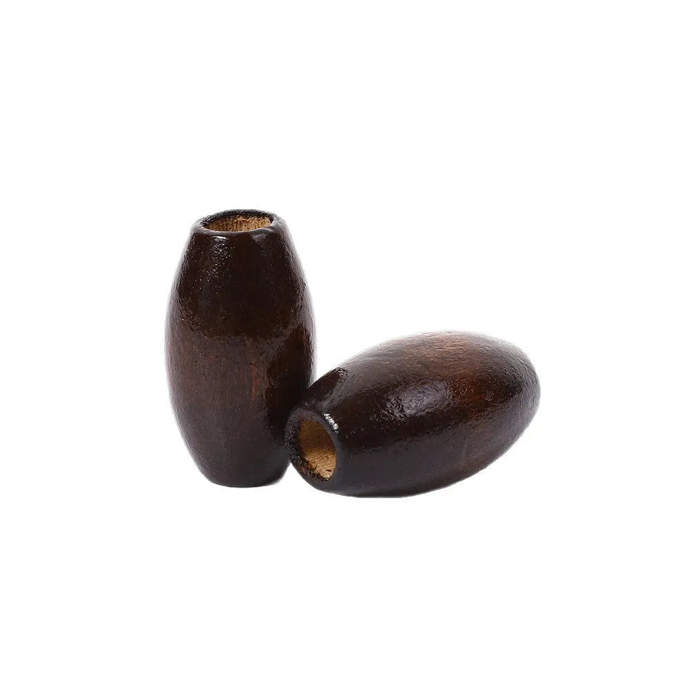 Dark coffee coloured oval wooden bead with M-shaped raised design, 25mm size