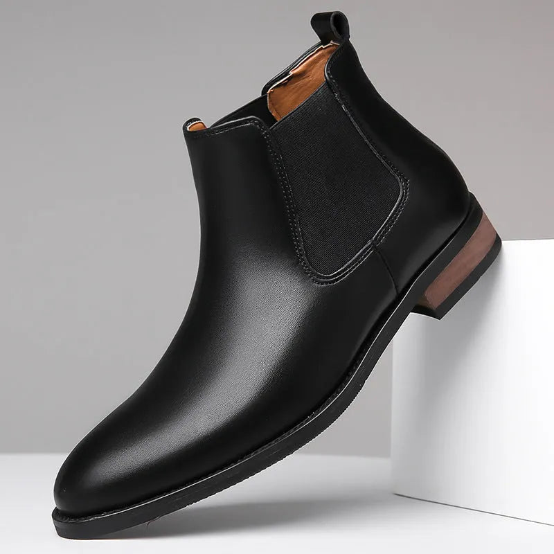 Men's black pointed toe Chelsea boots with mid-calf height and decorative stitching