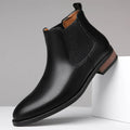 Men's black pointed toe Chelsea boots with mid-calf height and decorative stitching