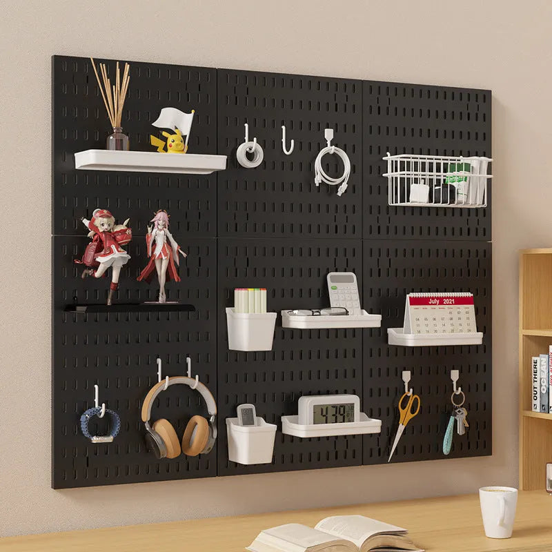 White punch-free plastic cable organisation board mounted on a wall with wires neatly wrapped.