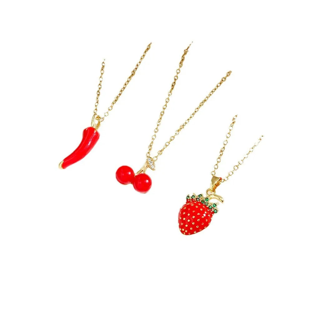 Titanium steel fashion necklace with indie cherry pendant on an O-ring chain, shown in golden colour.