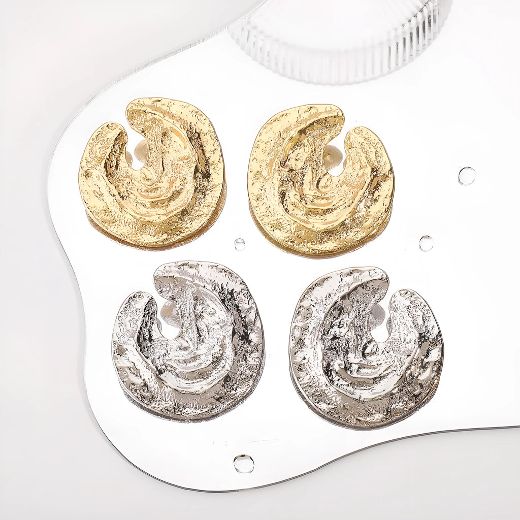 Geometric women's earrings with gold pleating and a concave-convex textured surface.