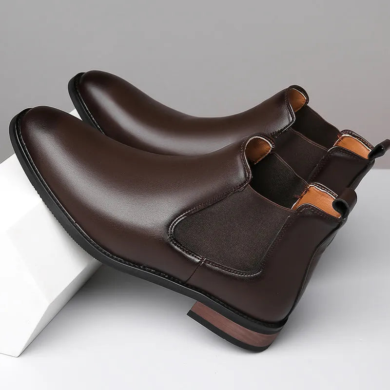 Men's black pointed toe Chelsea boots with mid-calf height and decorative stitching
