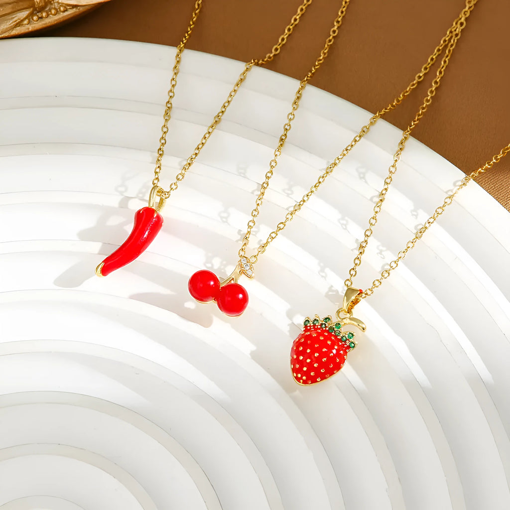 Gold titanium steel necklace with a detailed cherry pendant on an O-ring chain.
