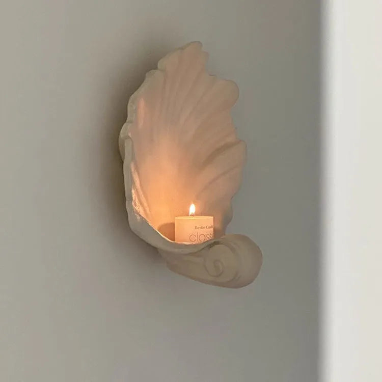 White resin fruit plate ornament shaped like a shell on a table