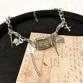 Dark style multi-layer cross necklace with twin clavicle chains showing electroplated alloy construction