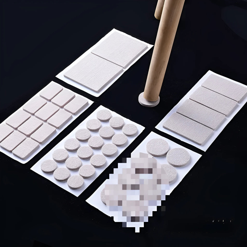 Assortment of beige round and square plastic non-slip furniture foot pads on a wooden floor.