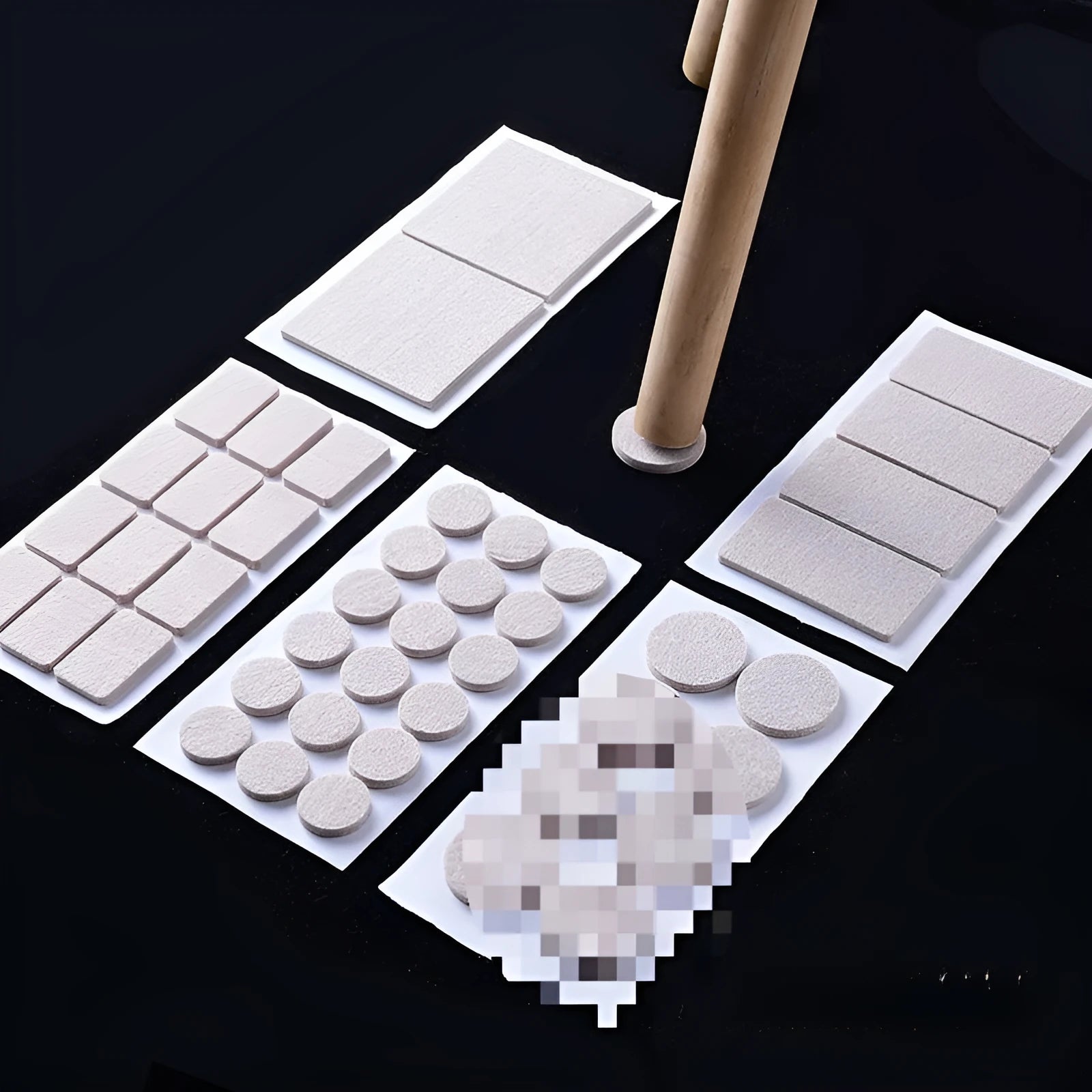 Assortment of beige round and square plastic non-slip furniture foot pads on a wooden floor.