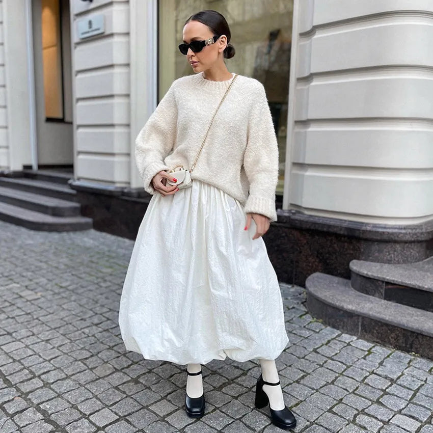 Women's solid colour long cotton skirt on a hanger, available in black and white.