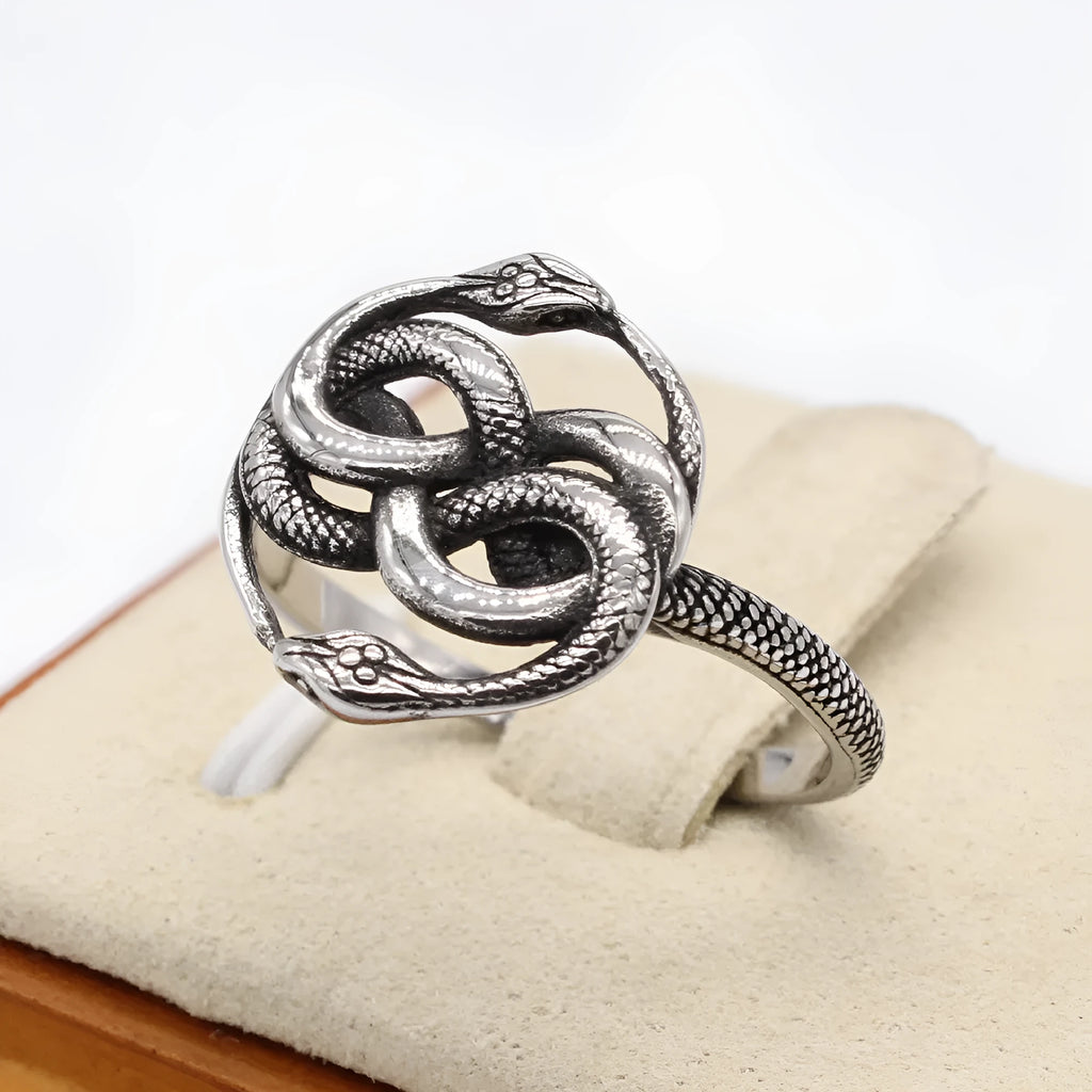 Close-up of a titanium steel double snake ring with a retro design on a hand, showing the intricate intertwined serpent detail.