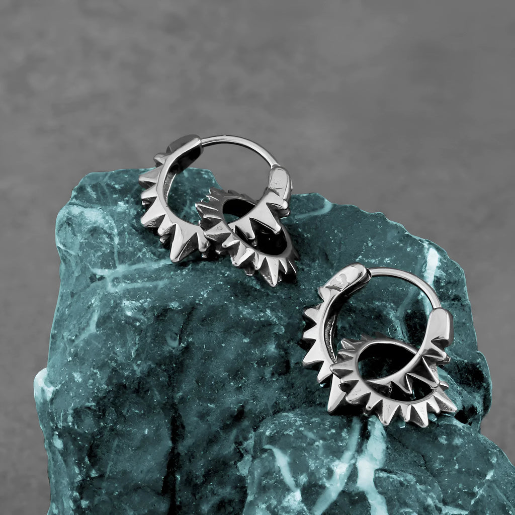 A pair of simple stainless steel round hoop earrings with a polished finish.
