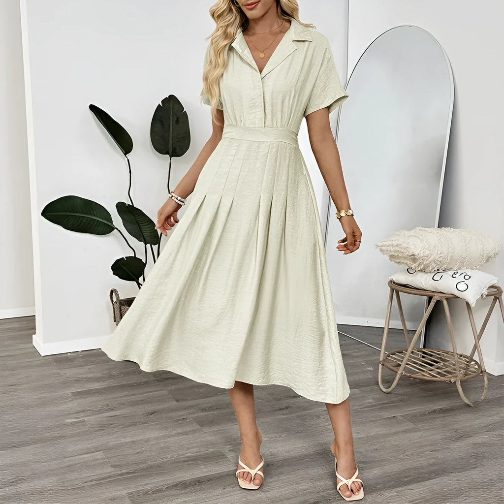 Light green commuter shirt dress with lapel collar, waist tie, and side pockets on a hanger.