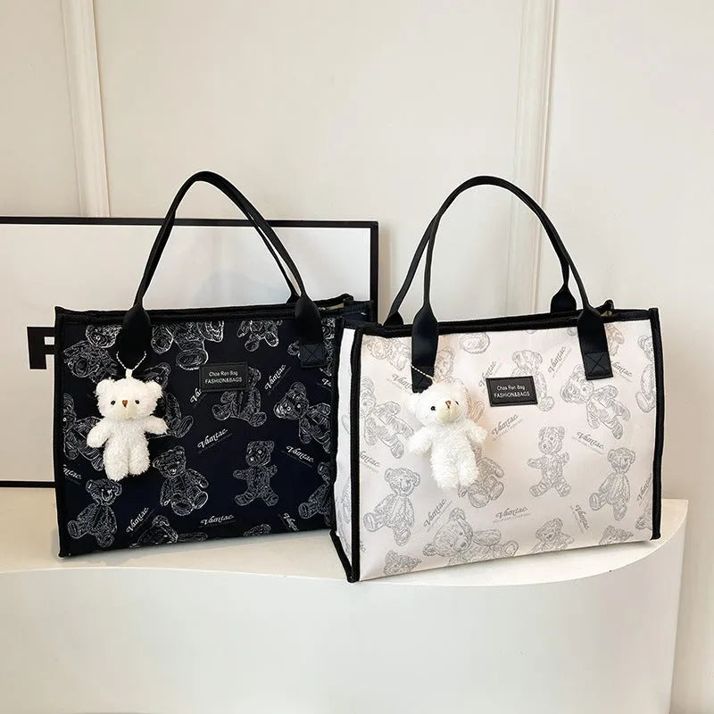 Women's printed canvas tote bag with rhombus pattern showing horizontal square shape and shoulder strap